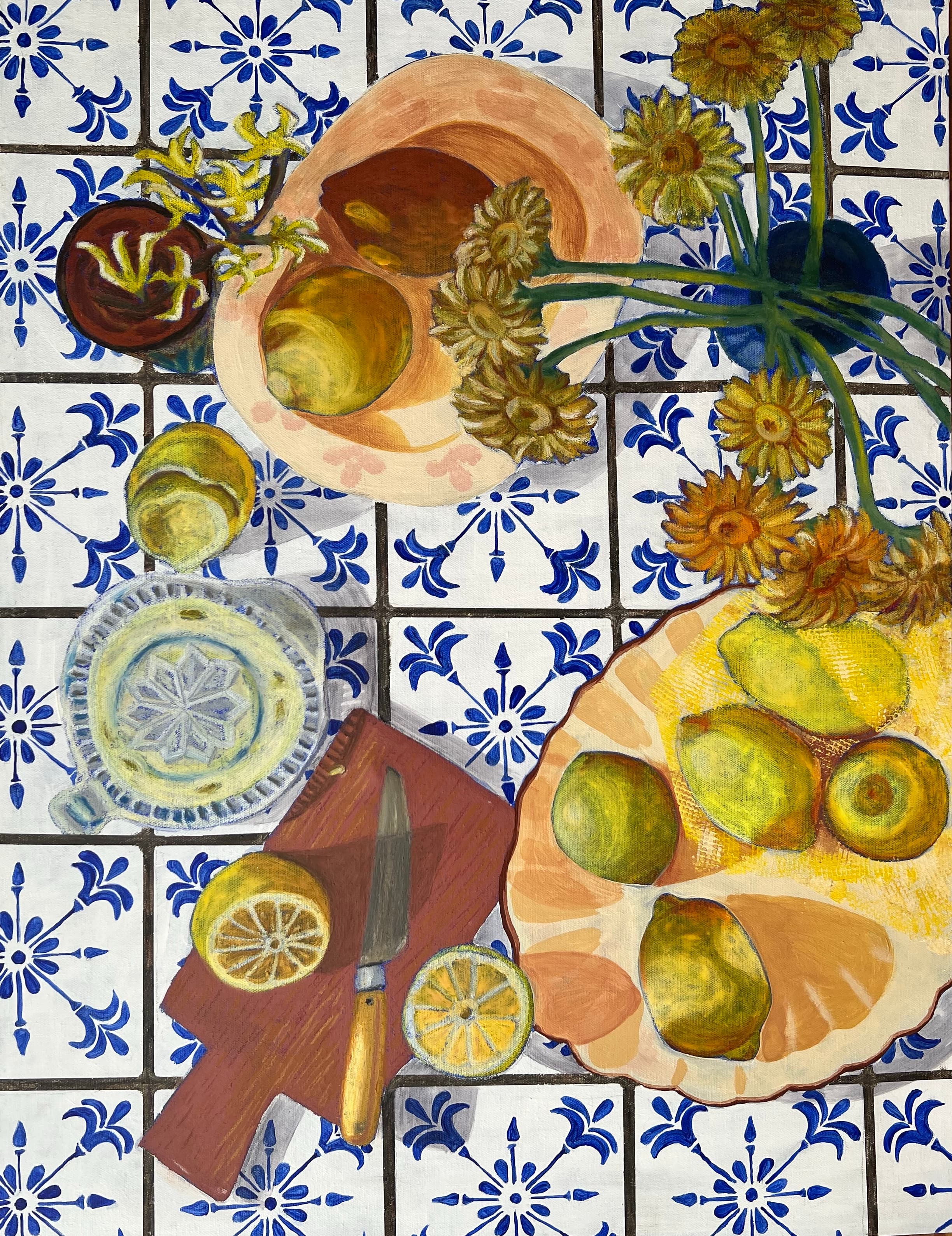 Lemons and a table setting against blue patterned tiles